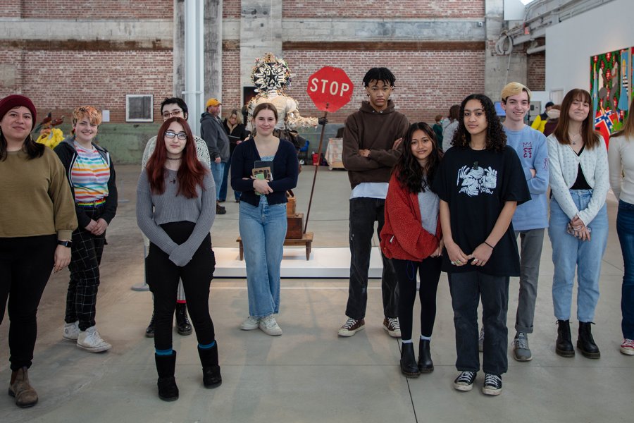A group of teens in an exhibition space